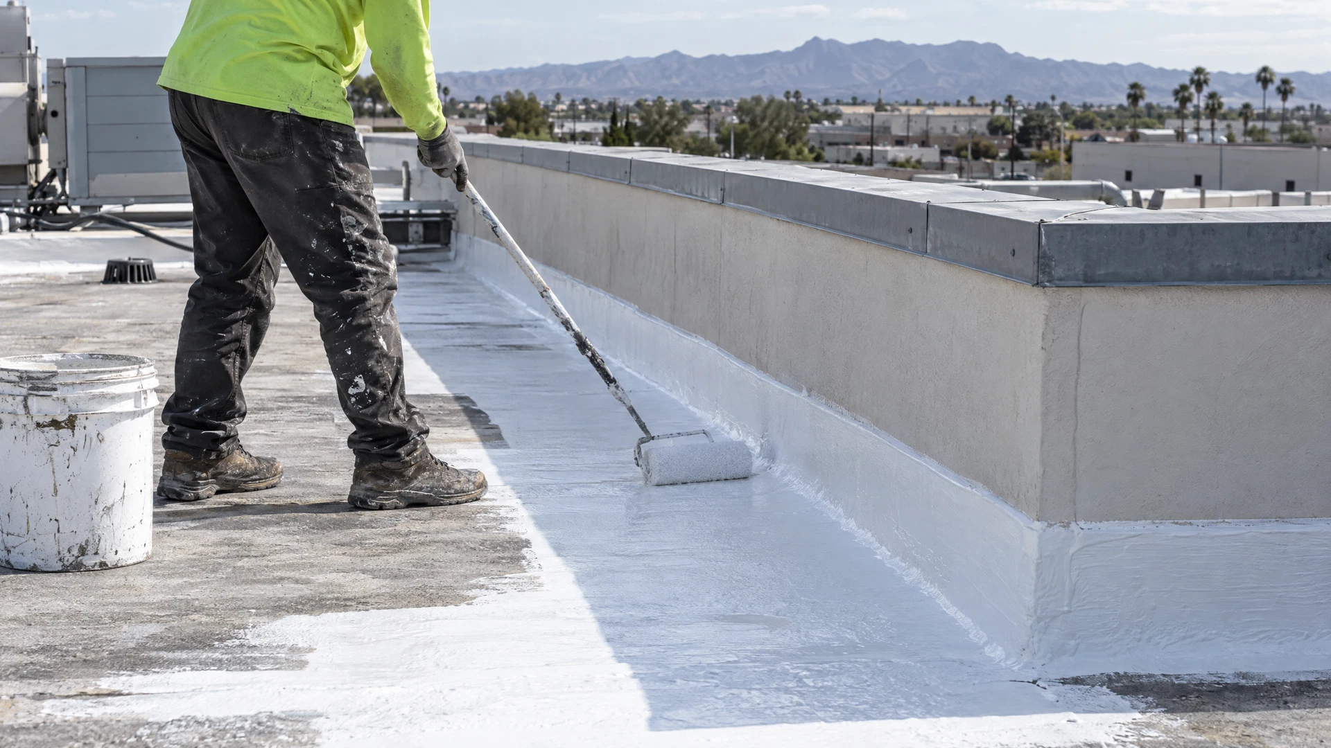 Acrylic coating detail work at commercial roof flashing